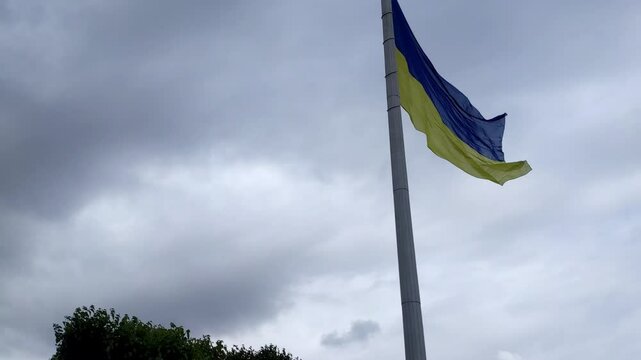 Ukraine flag waving on flagpole against sky