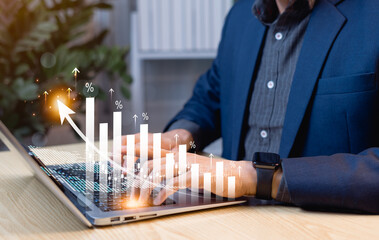 Businessman using laptop to analyze investment with rising arrow graph, forecasting economic growth...