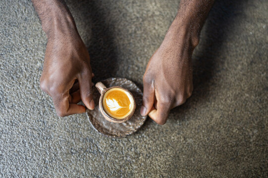 Man enjoying coffee in a cozy cafe setting