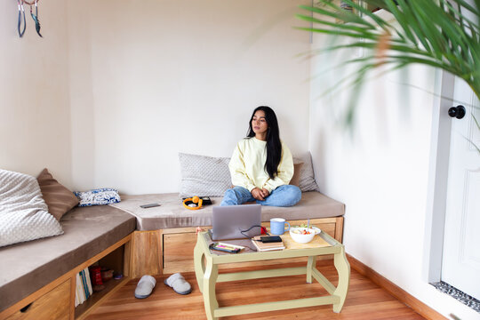 Latin woman relaxing at home in casual setting