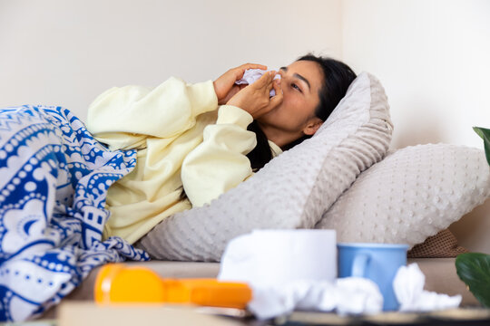 Woman resting at home while feeling under the weather