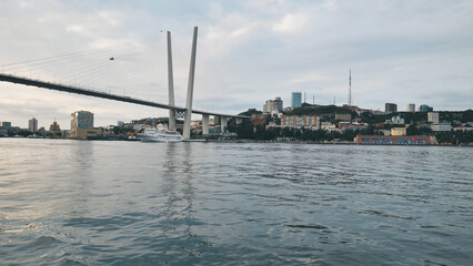 Fototapeta premium Scenic view of zolotoy rog bay featuring the iconic golden bridge and vladivostok cityscape in russia
