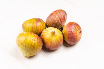 Freshly ripe figs. Healthy Mediterranean fig fruit. Fresh figs on a dark background. Beautiful blue violet figs with leaves, copy space, closeup
