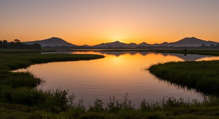 Obraz premium Serene Sunrise over Calm Lake and Mountain Range