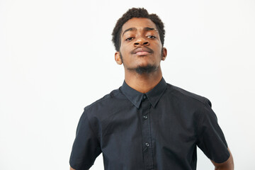 Confident black man in a casual black shirt, showcasing self-assurance and style. The image...