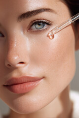 Close-up of a woman applying facial serum under her eye