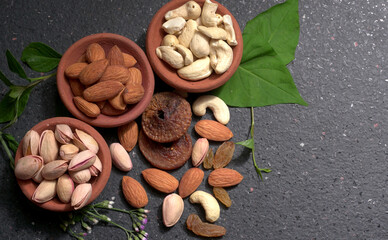 Pistachios or Pista nuts decorated with green leaves. plain background, top view.Flat lay.