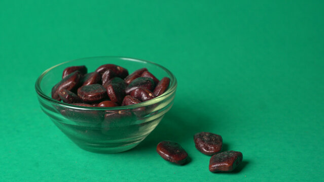 Tamarind fruit with seed isolated on green background with copy space for your text. Top view. Flat lay