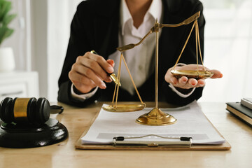 A professional lawyer sits at a desk surrounded by legal books, documents, and a gavel, providing...