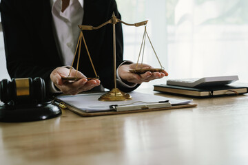 A professional lawyer sits at a desk surrounded by legal books, documents, and a gavel, providing...