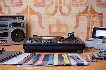 Vintage Turntable Record Player with Vinyl Collection and Retro Boombox Against Seventies Wallpaper Background for Music Enthusiasts
