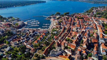 Aerial panoramic view around the old town of the city Waren on a sunny noon in summer in Germany.