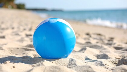 Obraz premium Blue beach ball on sand