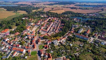 Aerial panoramic view around the old town of the city Penzlin on a sunny noon in summer in Germany.