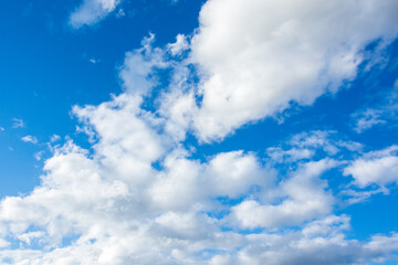 Blue Sky with Scattered Puffy White Clouds on a Clear Bright Day – Ideal for Background Use, Weather Concepts, and Graphic Design.