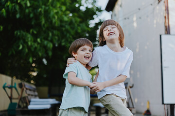 Happy boys playing together in a sunny garden, enjoying their carefree childhood moments and filled with laughter and joy in a vibrant outdoor setting.