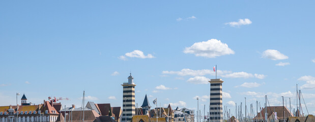 Scenic waterfront view featuring distinctive towers and boats on a sunny day in harbor town France  Rouen