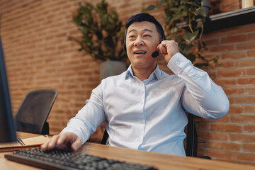 A professional individual working in customer support, wearing a headset, within a contemporary...