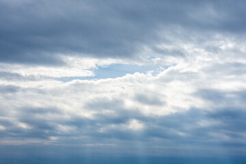 Dramatic Cloud Layers with Blue Sky Opening in the Center – Weather Concept and Natural Background for Design or Visual Use.