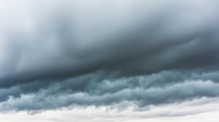 Dramatic storm clouds in deep blue, a sweeping skyscape with dynamic light, nature's raw power on display