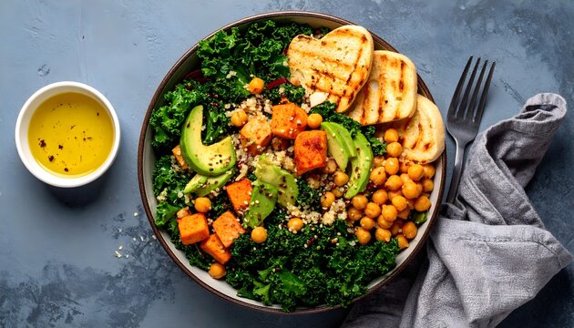 Healthy vegan salad with kale, quinoa, chickpeas, and lemon dressing, arranged in top-down flat lay with vibrant colors and fresh ingredients