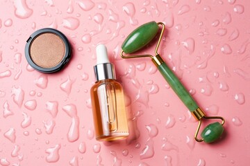Beauty products arranged on a pink surface with water droplets, featuring a jade roller, serum bottle, and bronzer compact, showcasing skincare and makeup essentials for a refreshing routine