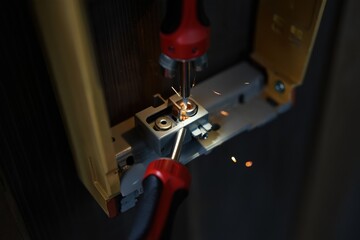 Close-up view of a tool in action, welding metal components together, with sparks flying, showcasing the intricate details of craftsmanship and the dynamic energy of the welding process