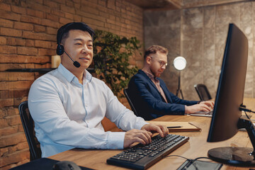 Two skilled professionals are collaborating effectively in a modern workspace that is equipped with...