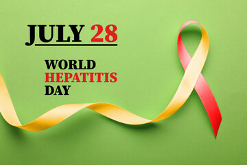 28th july World Hepatitis Day. Yellow-red awareness ribbon on light green background, top view