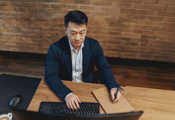 A dedicated professional engaged in work at a modern desk setup that inspires productivity and...
