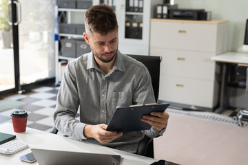 Businessman calculate and analyzing graph document financial with report and laptop in office.