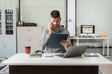 Businessman calculate and analyzing graph document financial with report and laptop in office.