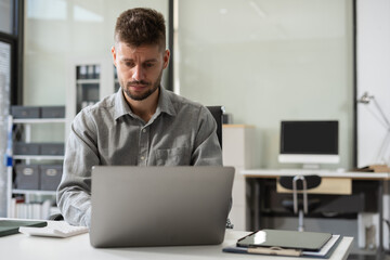Businessman calculate and analyzing graph document financial with report and laptop in office.