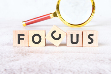 The concept word FOCUS is assembled from cubes. Search for words and information concept