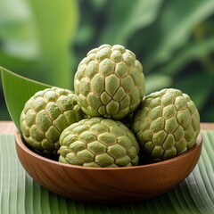 Obraz premium Tropical Srikaya Fruit with wooden plate container on natural banana leaf