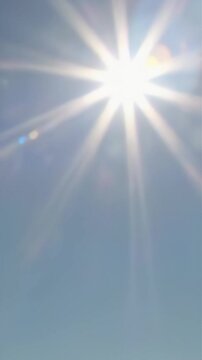 Summer sunshine. Image of sunlight in a cloudless blue sky　(Vertical video)