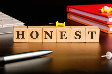 The concept word HONEST is assembled from cubes. Business integrity ethics honesty respect concept