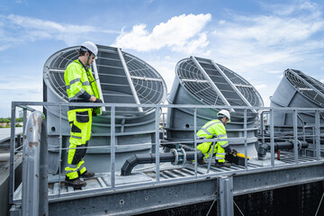 Professional engineer team service checking HVAC cooling tower, fan water Industry air conditioner