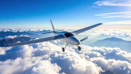 Obraz premium Scenic Flight Over Mountainous Landscape in Clear Blue Sky