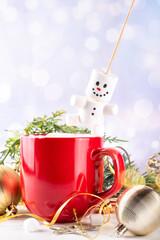 Christmas hot chocolate with funny snowman made with marshmallows