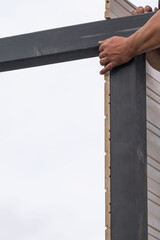 Aligning and screwing together the components of a wooden gazebo,