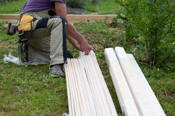 Worker unpacking white boards for building a gazebo