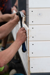 Installing boards in grooves when installing a wall in a gazebo.