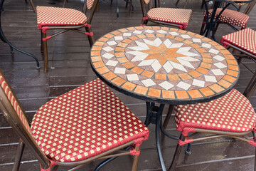 Tables in a street cafe with a bright pattern.