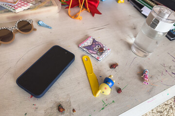Painted children's desk in the room, toys on the table.