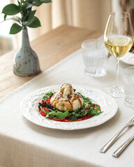 Portion of gourmet burrata salad with tomatoes and arugula