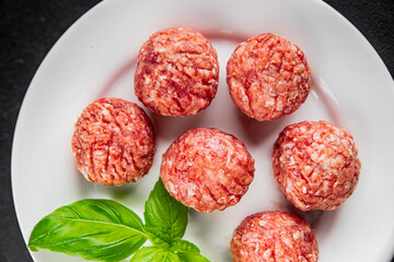Meatballs raw meat pork, beef, chicken fresh delicious gourmet food background on the table rustic...