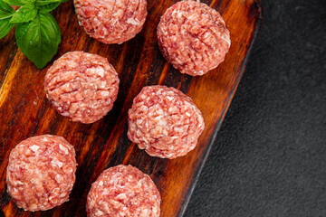 Meatballs raw meat pork, beef, chicken fresh delicious gourmet food background on the table rustic...