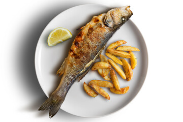 Plate with grilled sea bass and French fries and lemon