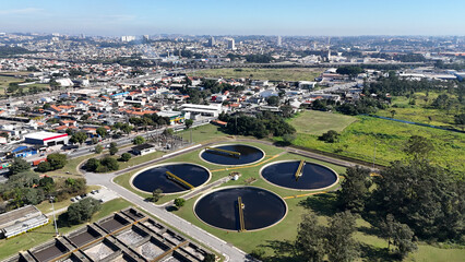Drone view of circular decanters and activated sludge tanks in a process and purify urban...